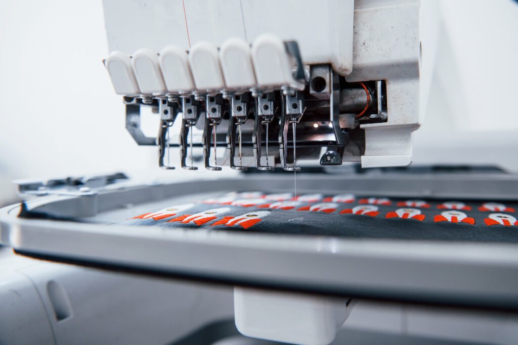 Close-up of an automatic machine creating custom embroidery patches.